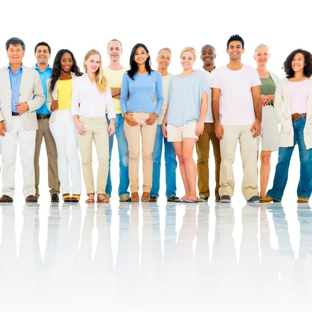 A smiling group of people of all ages standing together